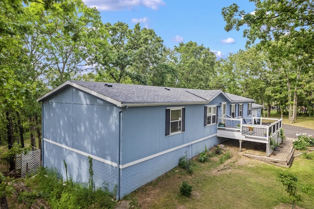 627 Reflection Rdg, Shell Knob, MO 65747 - view of side of property featuring a deck, roof with shingles, and view of wooded area