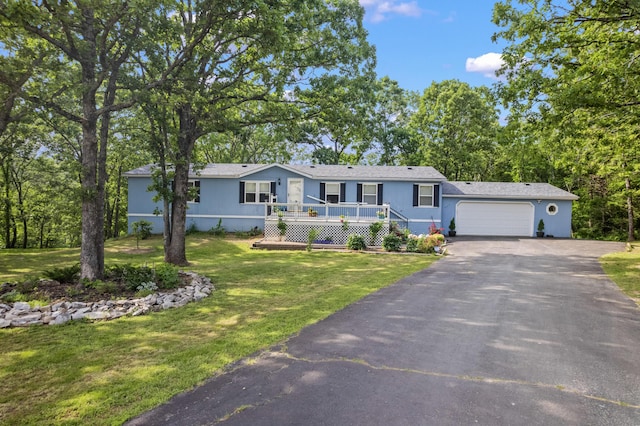 627 Reflection Rdg, Shell Knob, MO 65747 - view of front of home featuring driveway, an attached garage, a front lawn, and a deck