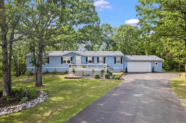 627 Reflection Rdg, Shell Knob, MO 65747 - view of front of home featuring asphalt driveway, a garage, a front lawn, and a wooden deck
