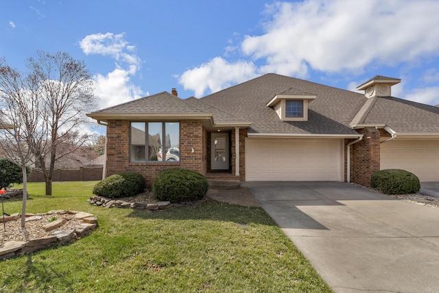 view of front of house featuring brick siding, a front yard, a garage, and a shingled roof