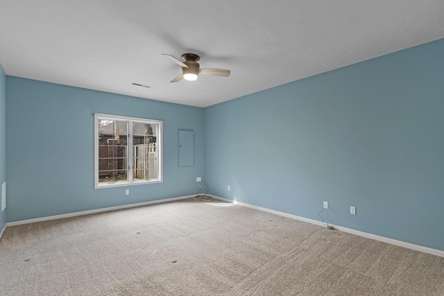 carpeted empty room featuring baseboards and a ceiling fan