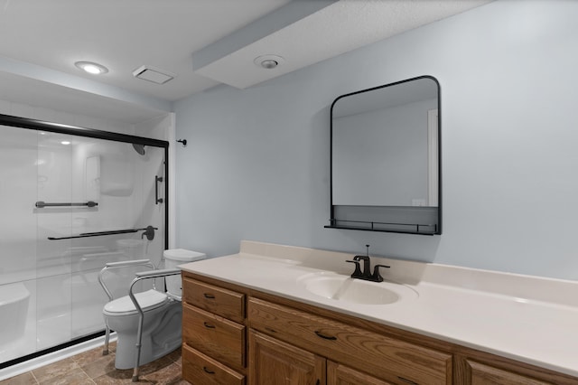 full bathroom featuring a shower stall, toilet, and vanity