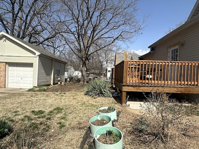 view of yard with an outbuilding, a garage, and a wooden deck