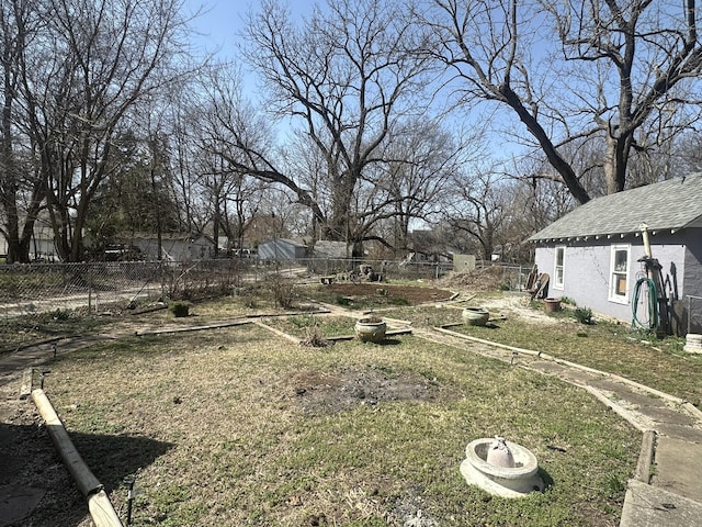 view of yard with a vegetable garden and fence