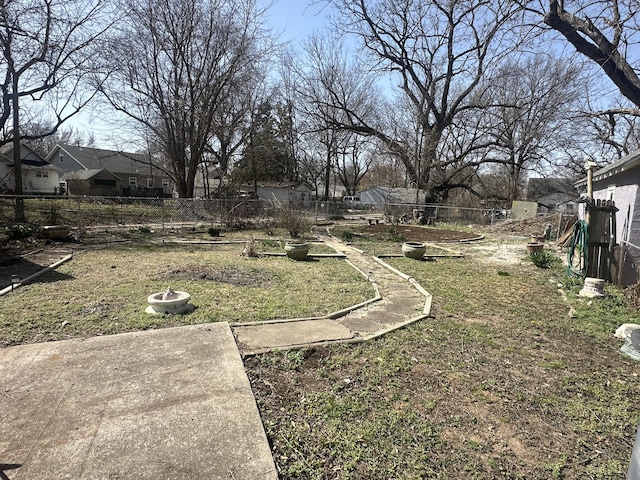 view of yard with a vegetable garden and fence