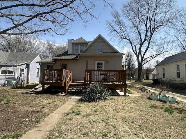 back of house featuring a deck