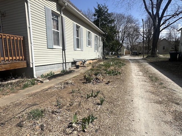 view of home's exterior with dirt driveway