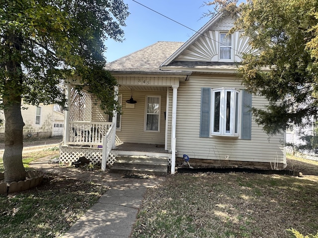 bungalow with roof with shingles and covered porch