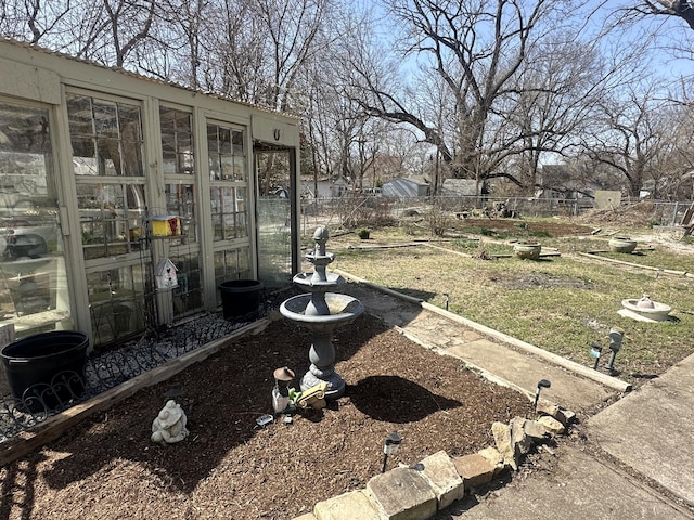 view of yard featuring a greenhouse, an outbuilding, and fence