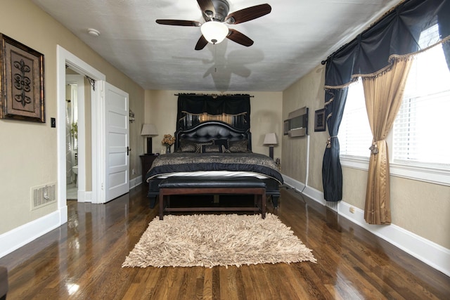 bedroom featuring visible vents, a ceiling fan, baseboards, and wood finished floors