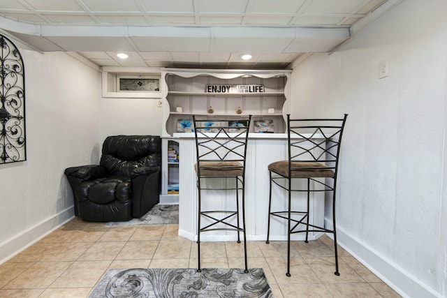 interior space featuring tile patterned flooring and baseboards