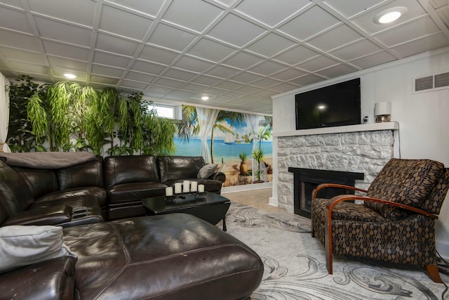 living room featuring visible vents and a stone fireplace