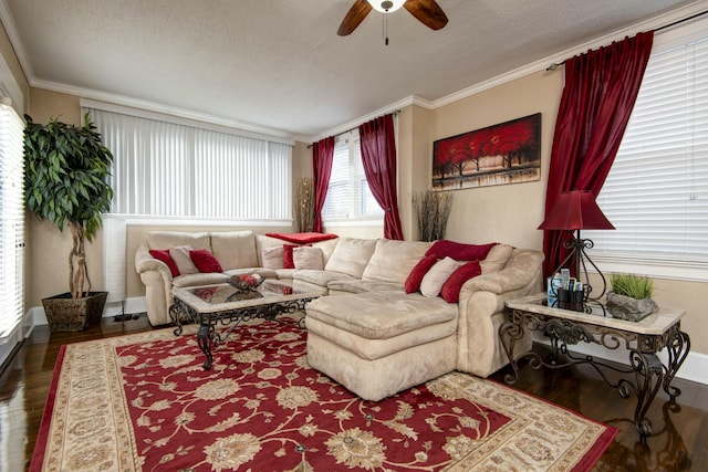 living area with a textured ceiling, crown molding, ceiling fan, and wood finished floors