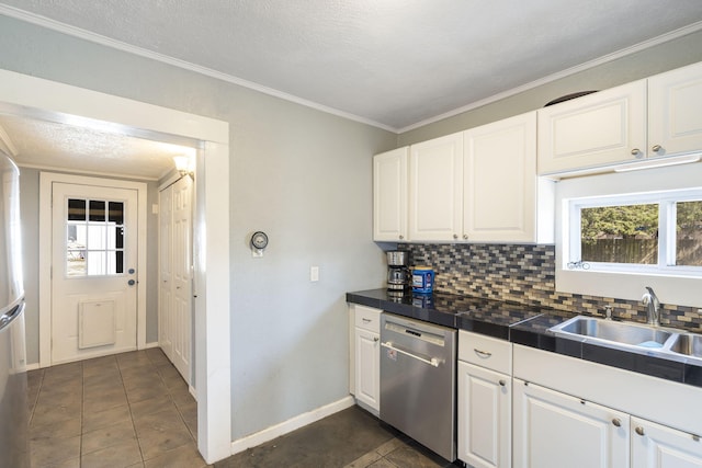 kitchen featuring a sink, decorative backsplash, stainless steel dishwasher, and white cabinetry