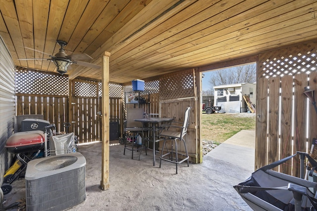 view of patio with central AC, a ceiling fan, and fence