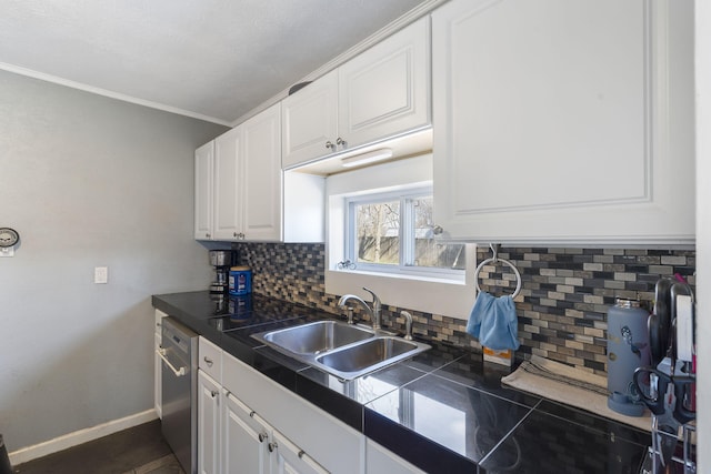 kitchen featuring a sink, baseboards, dishwasher, and white cabinetry