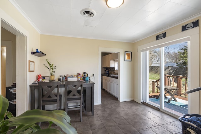 interior space featuring visible vents, crown molding, and dark tile patterned flooring