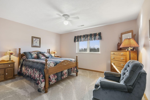 bedroom featuring visible vents, light colored carpet, baseboards, and a ceiling fan