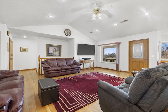 living room with visible vents, baseboards, light wood-type flooring, vaulted ceiling, and a ceiling fan