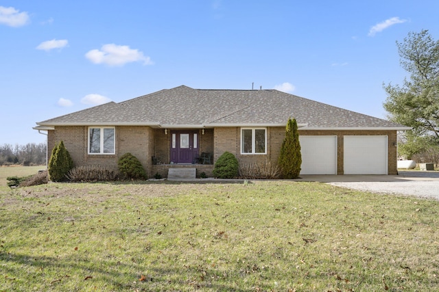 single story home featuring gravel driveway, an attached garage, brick siding, a front lawn, and a shingled roof