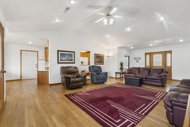 living room featuring visible vents, ceiling fan, vaulted ceiling, and light wood finished floors