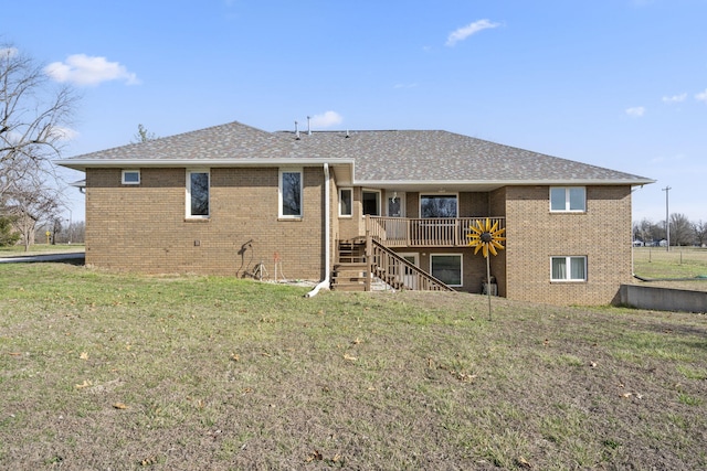 back of property with stairway, brick siding, a deck, and a yard