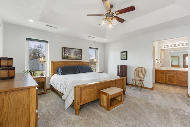 bedroom featuring baseboards, visible vents, recessed lighting, a raised ceiling, and light colored carpet