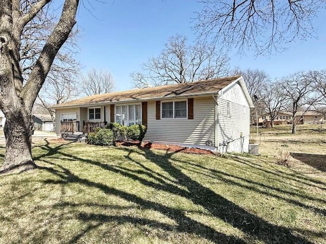 view of front of home with a front lawn and a garage