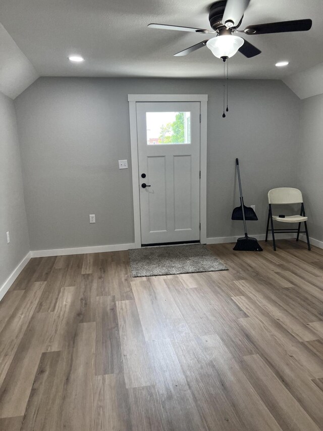 entrance foyer featuring baseboards, wood finished floors, a ceiling fan, and vaulted ceiling