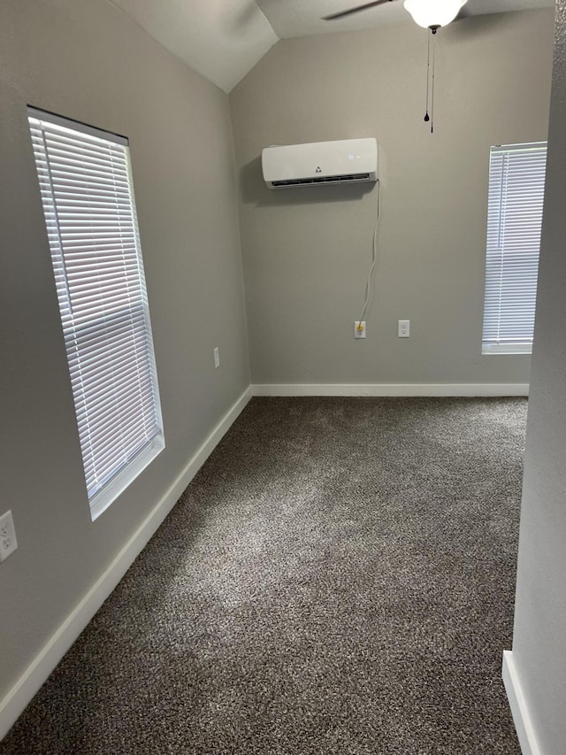 carpeted empty room with an AC wall unit, a ceiling fan, baseboards, and lofted ceiling