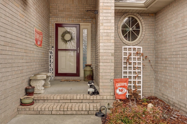 view of exterior entry with brick siding