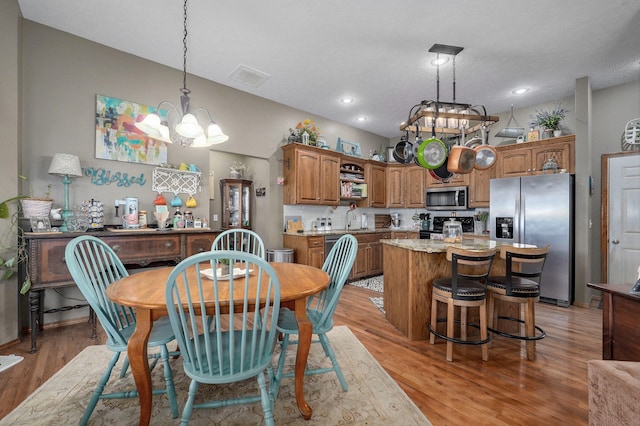 dining space with recessed lighting, light wood-style flooring, visible vents, and a chandelier