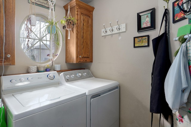 laundry room featuring cabinet space and separate washer and dryer