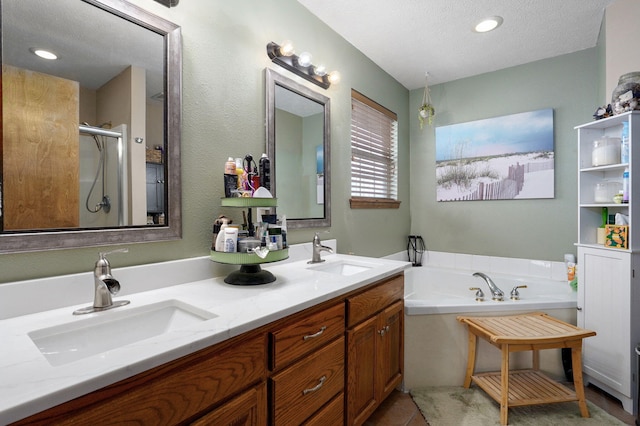 full bathroom featuring double vanity, a bath, a stall shower, and a sink