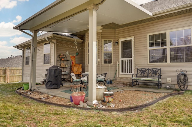 view of patio featuring grilling area, fence, and entry steps