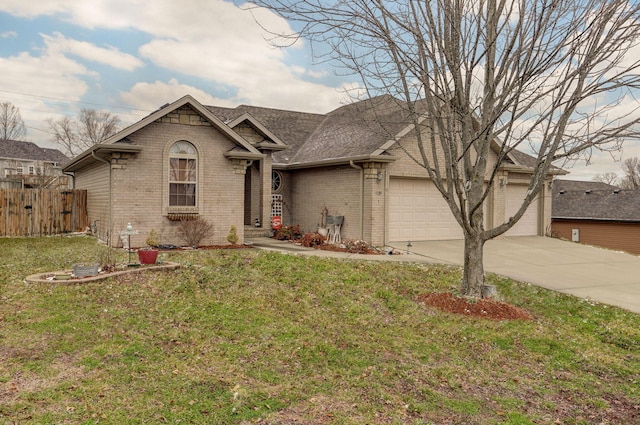 view of front of home with brick siding, a garage, a front lawn, and fence