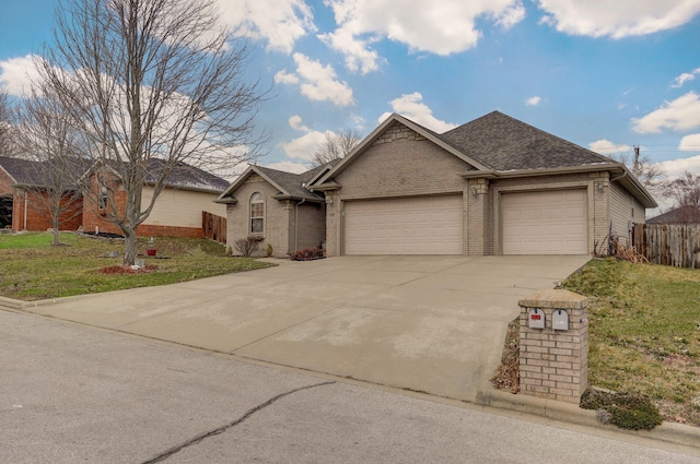 single story home with brick siding, a shingled roof, a front lawn, concrete driveway, and an attached garage