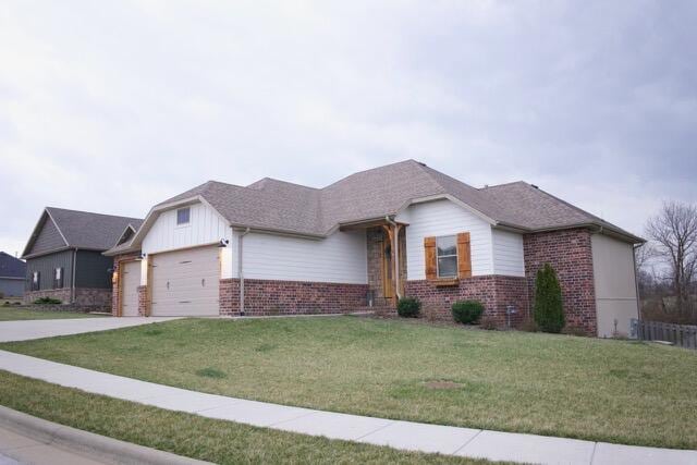 ranch-style house with a garage, driveway, brick siding, and a front lawn