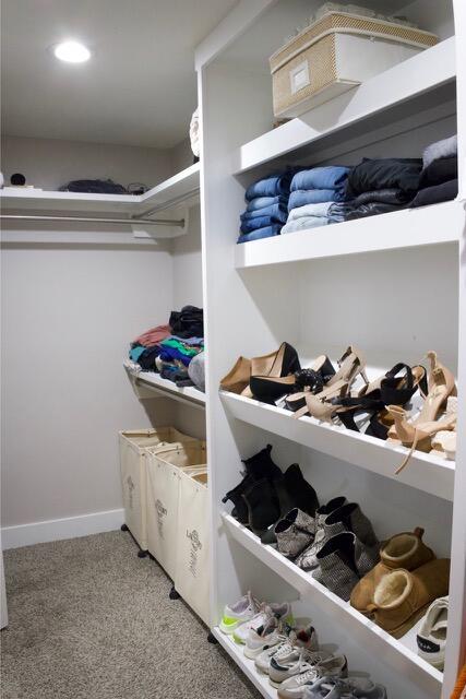 spacious closet featuring light colored carpet