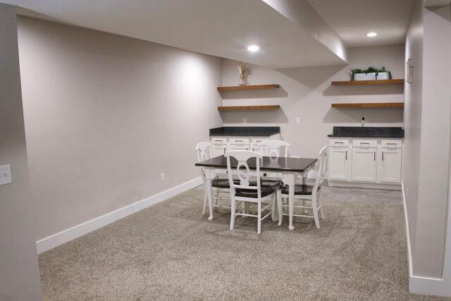 dining area featuring recessed lighting, baseboards, and light carpet