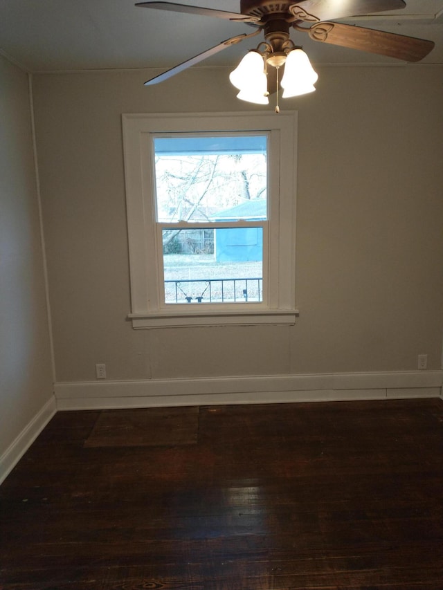 unfurnished room with dark wood finished floors, baseboards, and ceiling fan