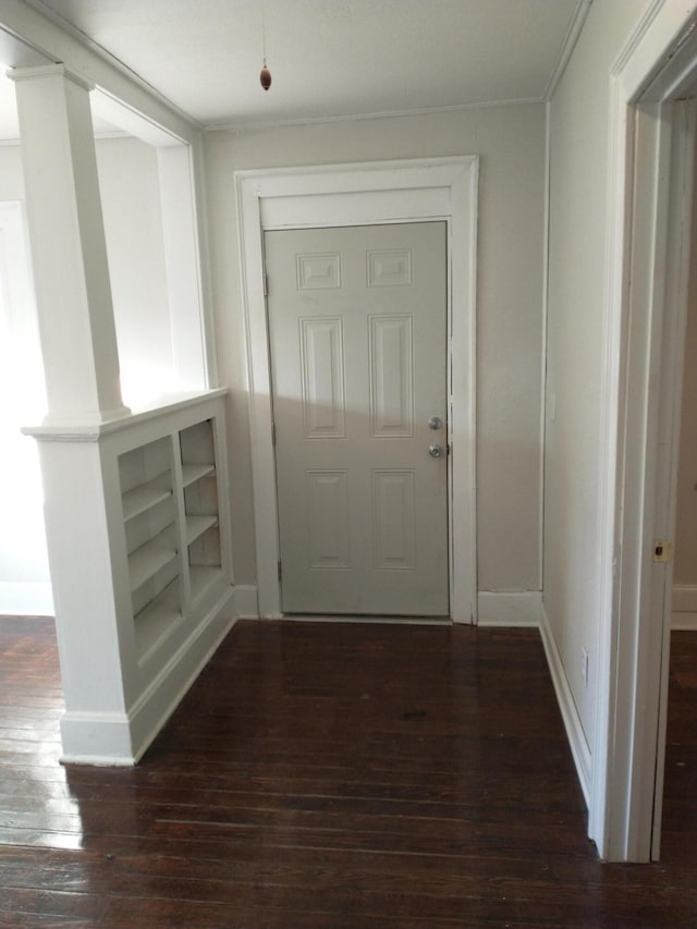 doorway to outside featuring dark wood-type flooring and baseboards