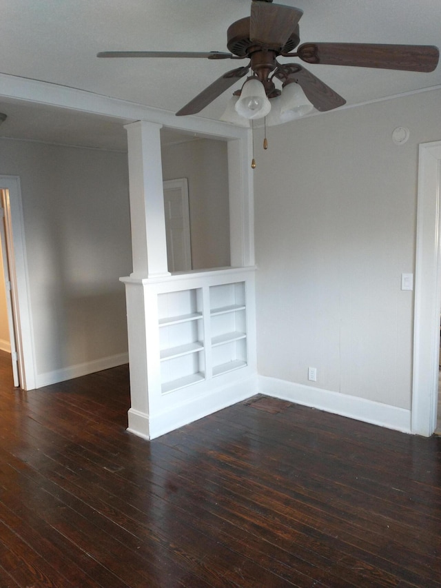 empty room with baseboards, wood-type flooring, and a ceiling fan