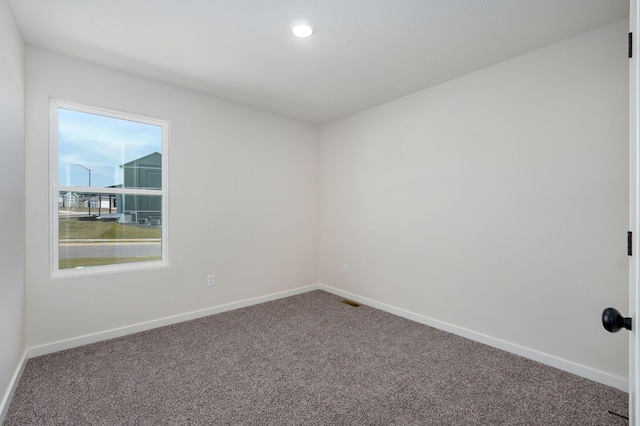 spare room with carpet flooring and baseboards