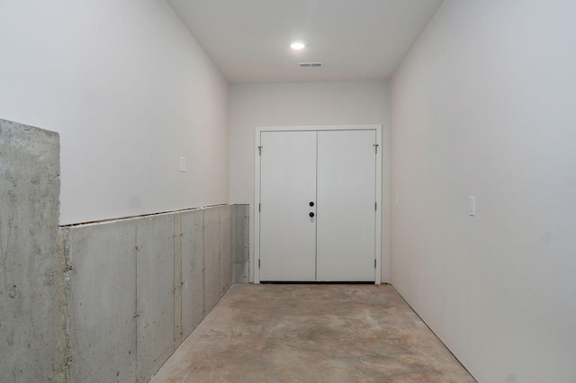 interior space with unfinished concrete flooring and visible vents