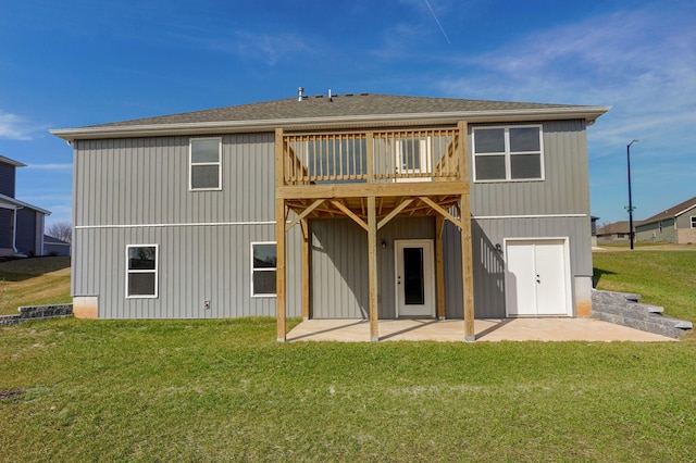 back of property featuring a yard, a patio, and a wooden deck