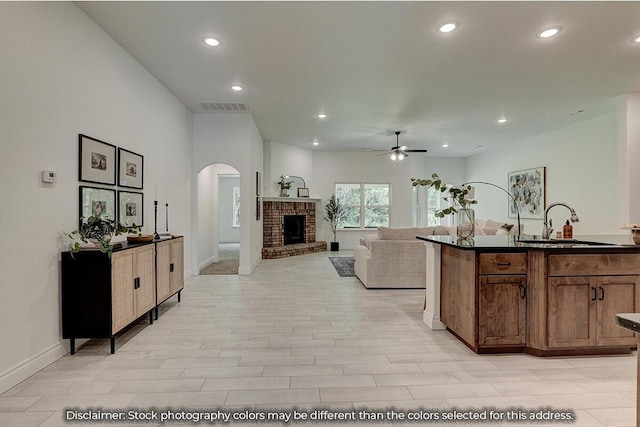 5202 S April Ct, Battlefield, MO 65619 - living room featuring visible vents, recessed lighting, a fireplace, arched walkways, and a ceiling fan