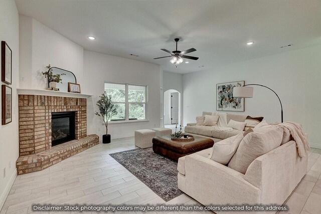 5202 S April Ct, Battlefield, MO 65619 - living area featuring recessed lighting, a fireplace, arched walkways, and ceiling fan