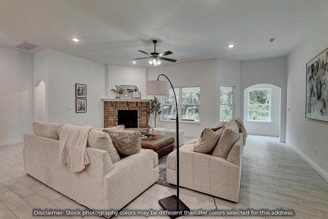 5202 S April Ct, Battlefield, MO 65619 - living area with a ceiling fan, recessed lighting, arched walkways, a fireplace, and baseboards