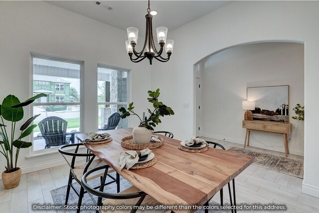 5202 S April Ct, Battlefield, MO 65619 - dining space with visible vents, arched walkways, baseboards, and a chandelier